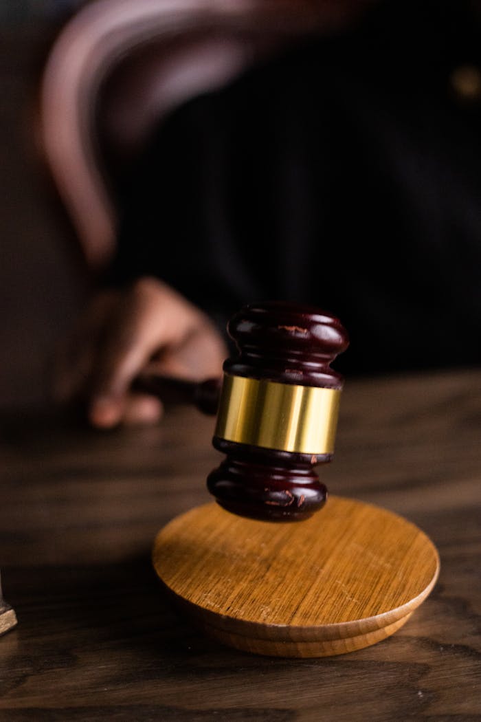 Close-up of a judge's gavel on a wooden block, symbolizing justice and law.